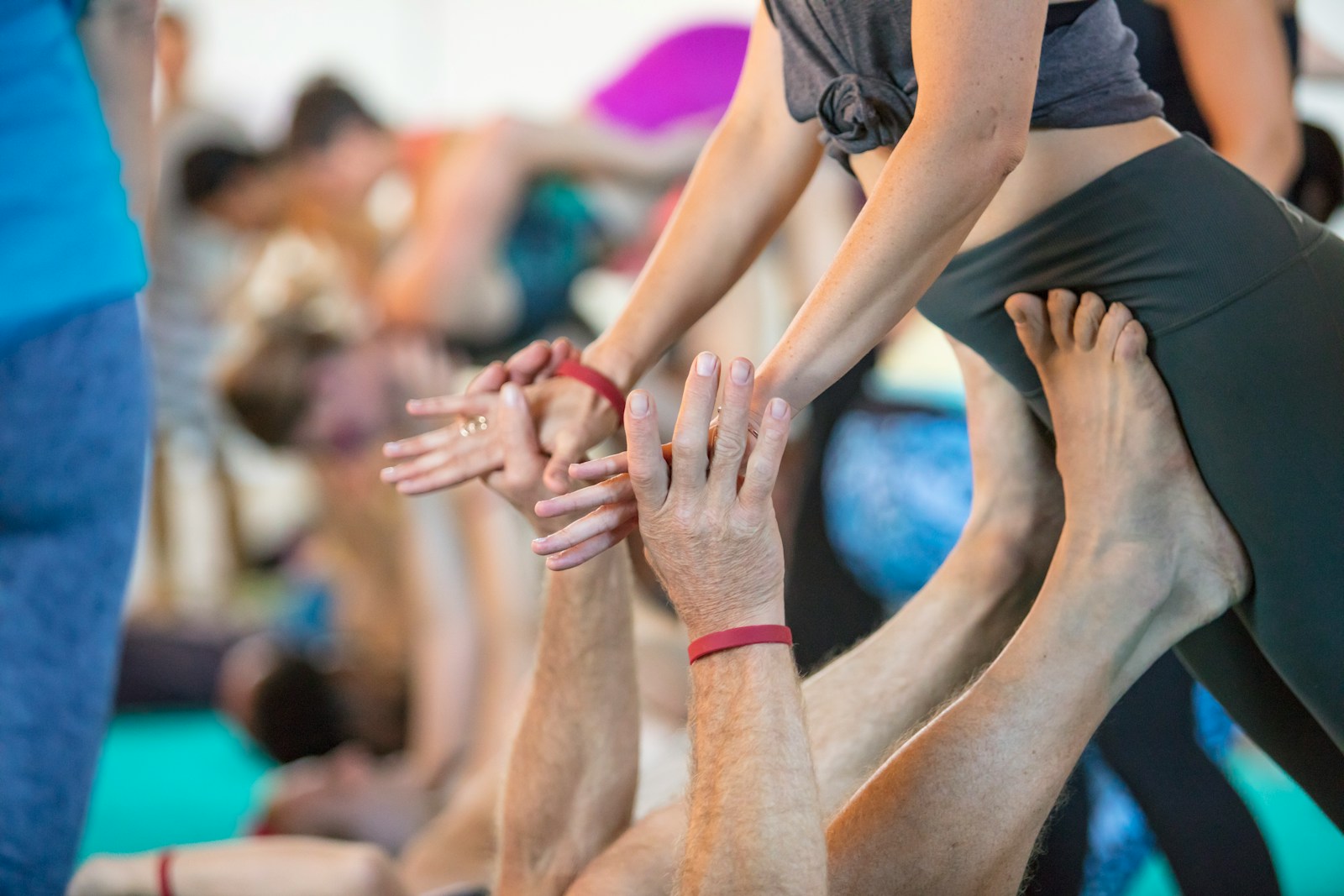 a group of people standing in a circle with their hands together